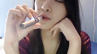 Asian model Meowsy smoking and sucking dildo