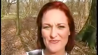 Salacious redhead falls to her knees and sucks dick outdoors