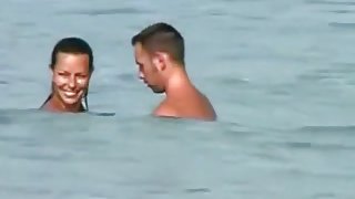 Voyeur tapes a girl sucking her bf's cock on a nude beach