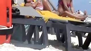 Pretty brunette smokes a cig on a nude beach in hidden cam clip