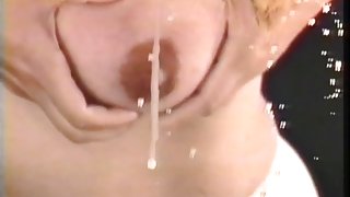 Lactating bitch squeezes milk from her big billibongs